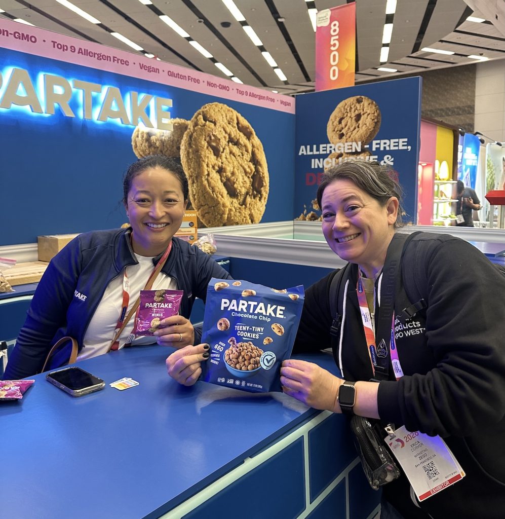Erica holding a bag of Partake Teeny-Tiny Cookies with Partake Founder Denise